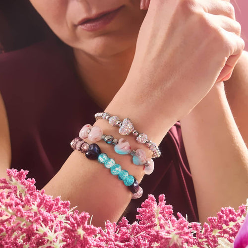 Unicorn White Crystal Kikiballa Cascade Heart Bracelet with sparkling crystal hearts and silver beads on stretchable band worn by model by NOGU